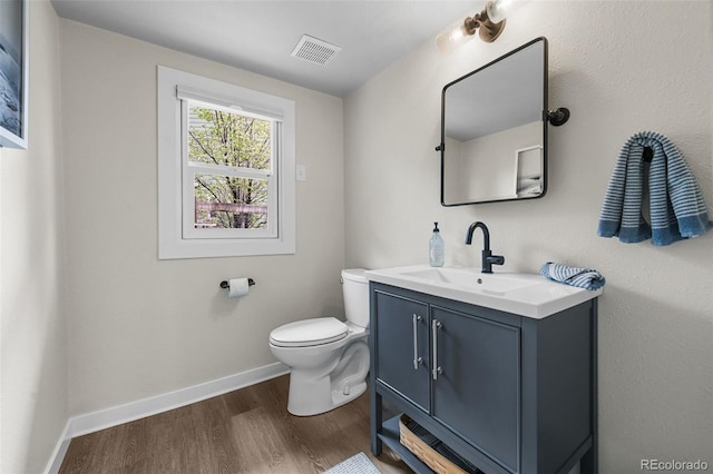10743 W Turtle Mtn, Littleton, CO 80127 - bathroom with toilet, wood finished floors, vanity, and baseboards