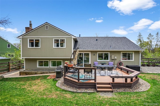 10743 W Turtle Mtn, Littleton, CO 80127 - back of property with a deck, roof with shingles, a chimney, and outdoor dining space