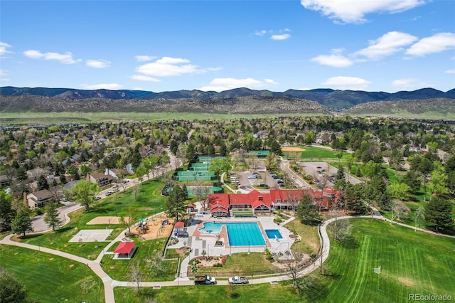 10743 W Turtle Mtn, Littleton, CO 80127 - aerial view of property and surrounding area with a pool area, a mountainous background, and nearby suburban area