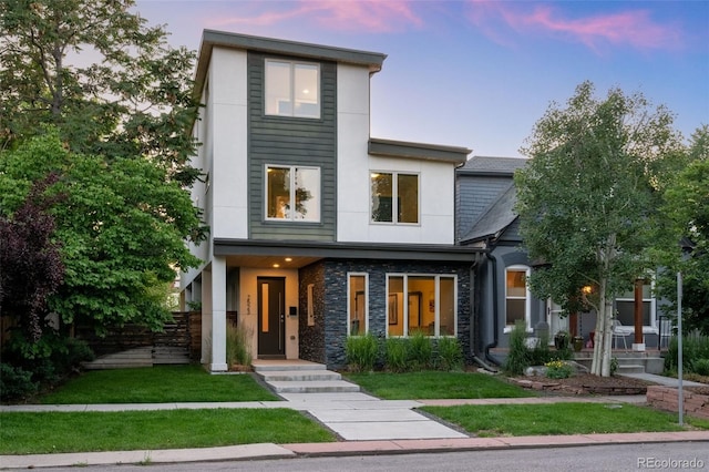 2523 N Humboldt St, Denver, CO 80205 - modern home featuring stone siding, stucco siding, and a front yard
