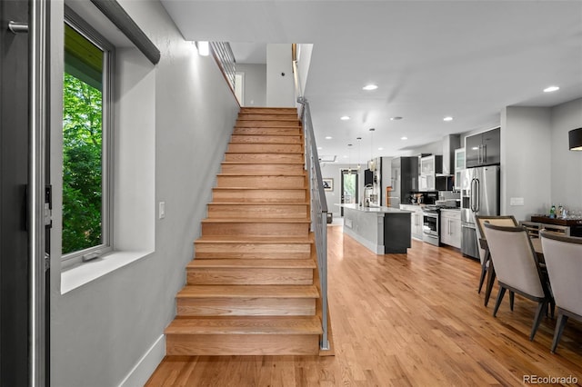 2523 N Humboldt St, Denver, CO 80205 - staircase featuring wood finished floors and recessed lighting