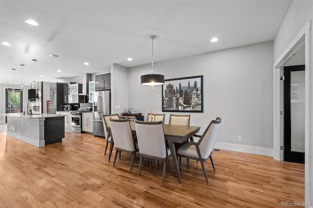 2523 N Humboldt St, Denver, CO 80205 - dining area with light wood-style floors and recessed lighting