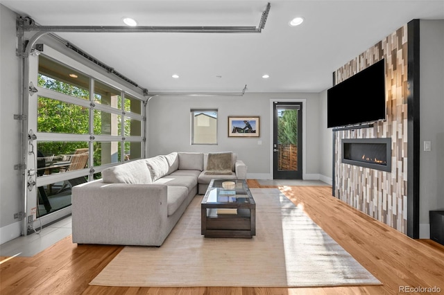 2523 N Humboldt St, Denver, CO 80205 - living area featuring recessed lighting, a warm lit fireplace, and wood finished floors