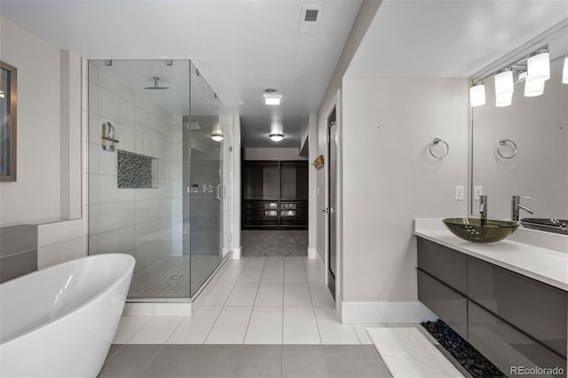 2523 N Humboldt St, Denver, CO 80205 - bathroom featuring a shower stall, a soaking tub, double vanity, and tile patterned floors