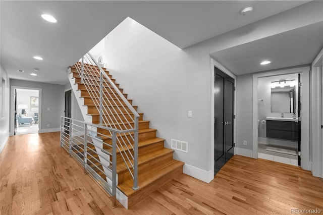 2523 N Humboldt St, Denver, CO 80205 - stairway with wood finished floors and recessed lighting