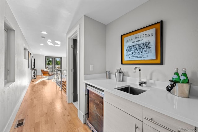 2523 N Humboldt St, Denver, CO 80205 - indoor wet bar featuring beverage cooler, light wood-style flooring, and recessed lighting