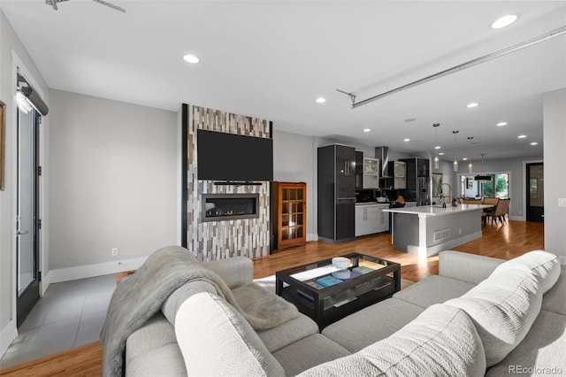 2523 N Humboldt St, Denver, CO 80205 - living room featuring recessed lighting, a large fireplace, and light wood-type flooring