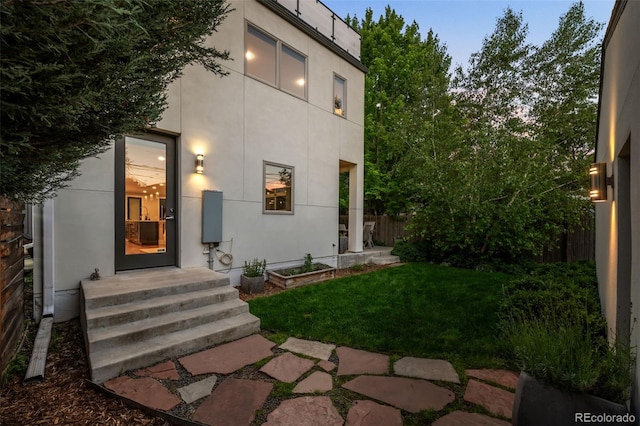 2523 N Humboldt St, Denver, CO 80205 - view of exterior entry with a yard and stucco siding