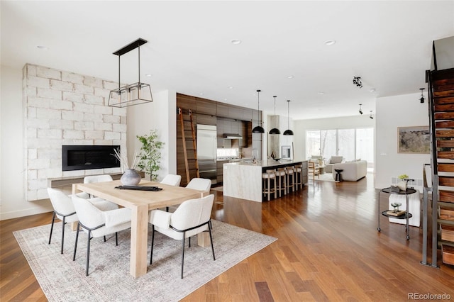 dining space featuring wood finished floors and recessed lighting