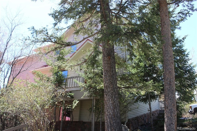 view of side of property with a balcony