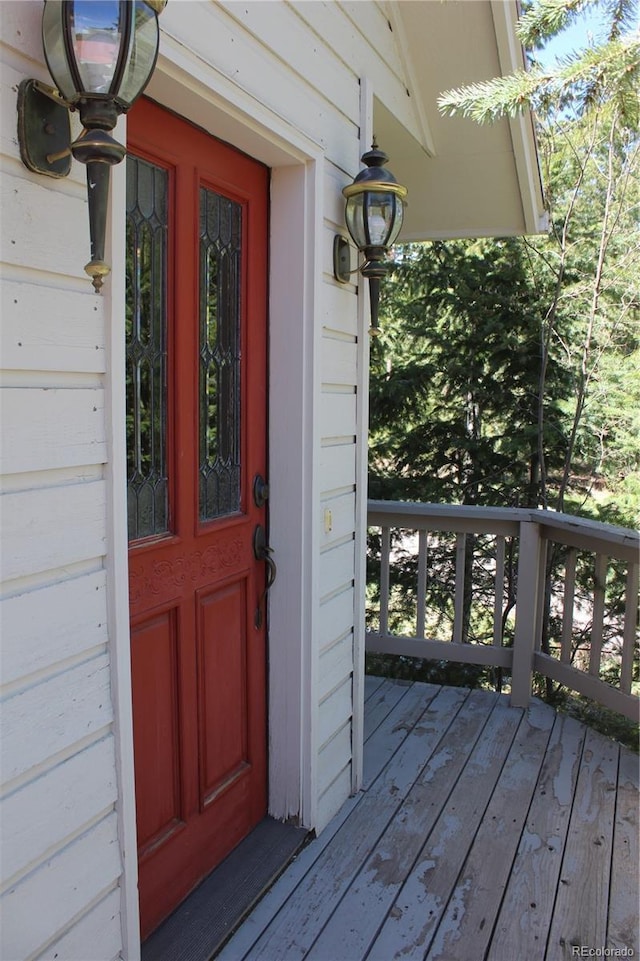view of exterior entry featuring a deck