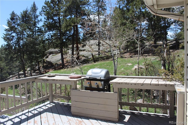 wooden terrace featuring a grill