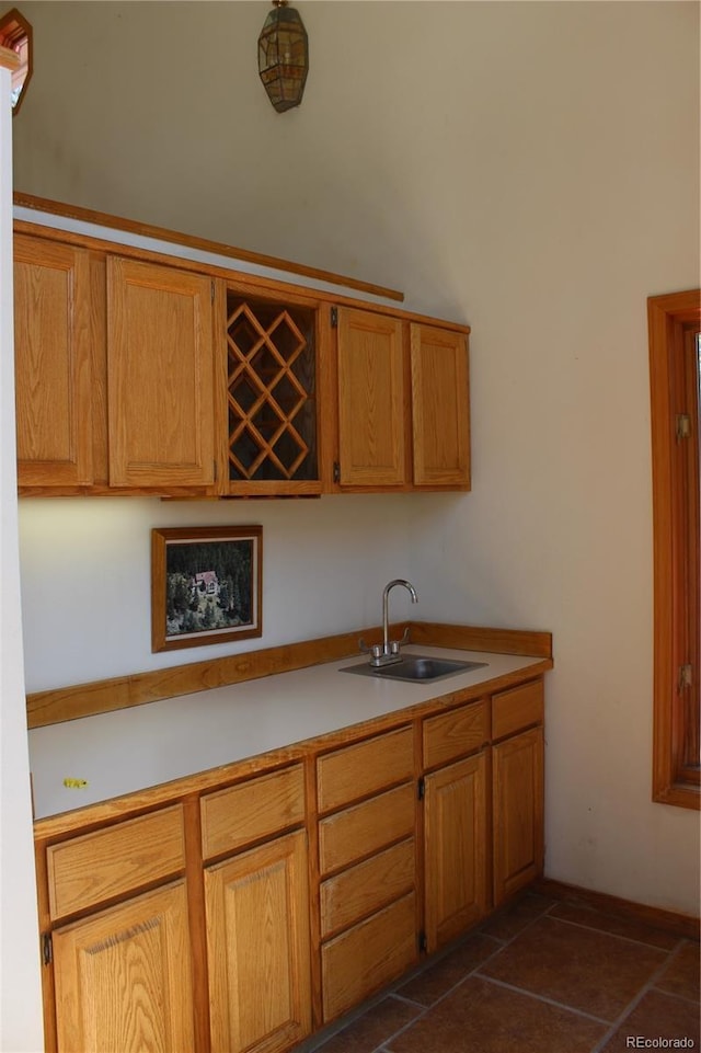 kitchen featuring a sink, light countertops, and brown cabinets