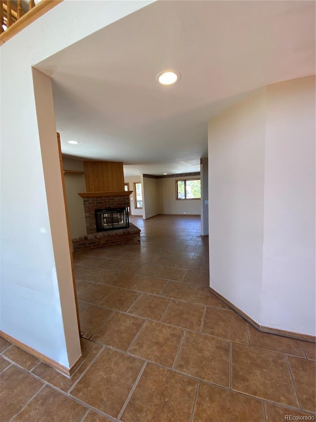 hallway featuring baseboards and recessed lighting