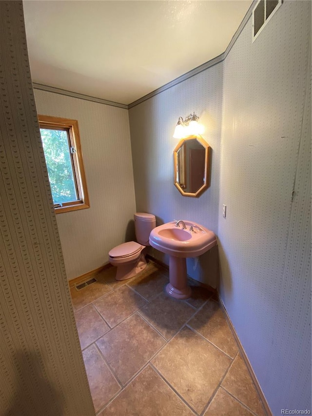 bathroom featuring baseboards, tile patterned flooring, toilet, and visible vents