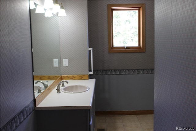 bathroom featuring tile patterned floors, vanity, and a chandelier
