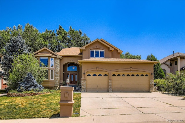 7482 Routt Ln, Arvada, CO 80005 - mediterranean / spanish house featuring stucco siding, stone siding, concrete driveway, an attached garage, and french doors