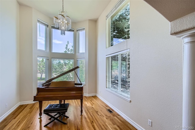 7482 Routt Ln, Arvada, CO 80005 - sitting room with a chandelier, plenty of natural light, and wood finished floors