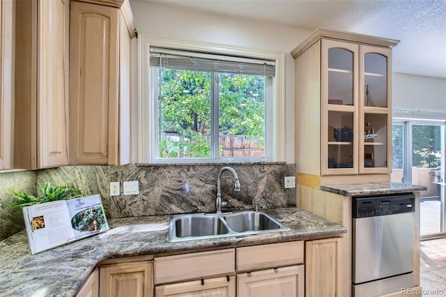 7482 Routt Ln, Arvada, CO 80005 - kitchen with dishwasher, light brown cabinetry, plenty of natural light, backsplash, and a textured ceiling