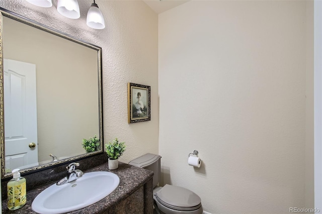 7482 Routt Ln, Arvada, CO 80005 - half bathroom with vanity and a textured wall