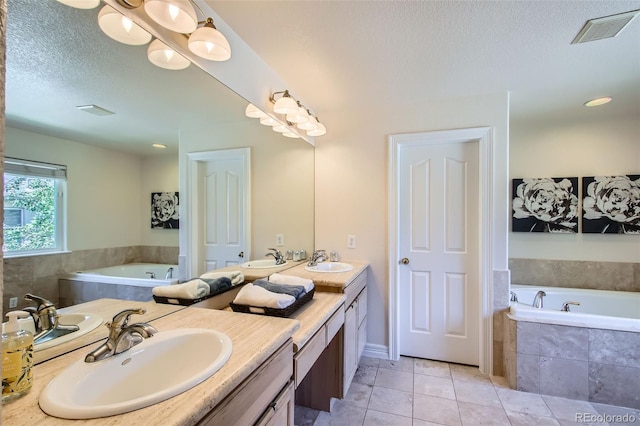 7482 Routt Ln, Arvada, CO 80005 - bathroom with double vanity, a garden tub, tile patterned flooring, and a textured ceiling