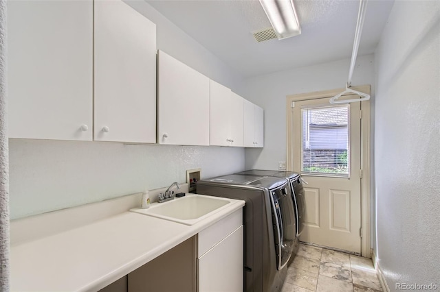 7482 Routt Ln, Arvada, CO 80005 - laundry room featuring cabinet space and washer and dryer