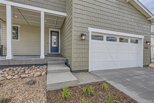 entrance to property with covered porch and a garage