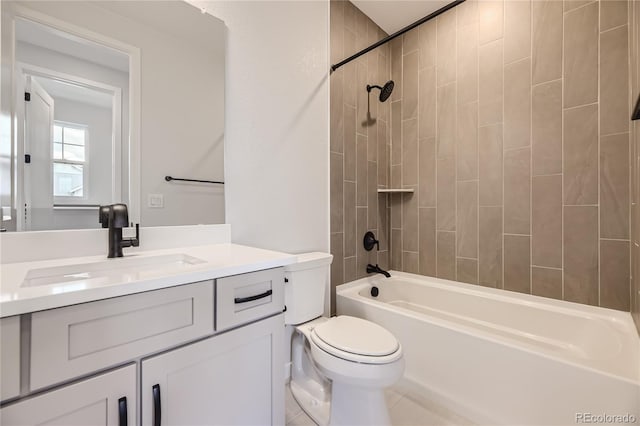 full bathroom with toilet, vanity, and tiled shower / bath