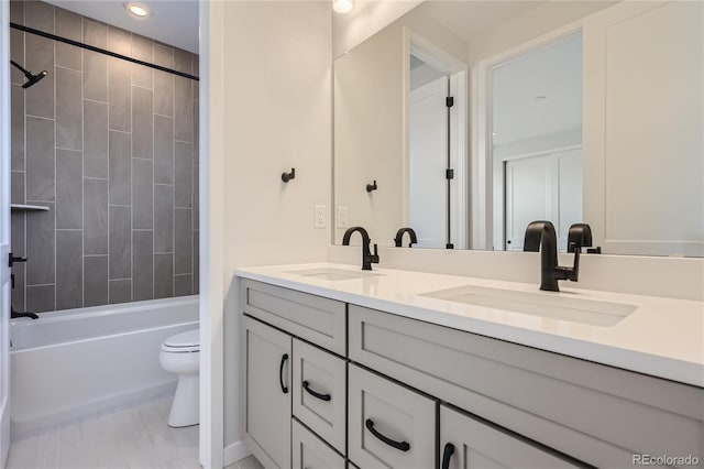 full bathroom featuring vanity, toilet, and tiled shower / bath