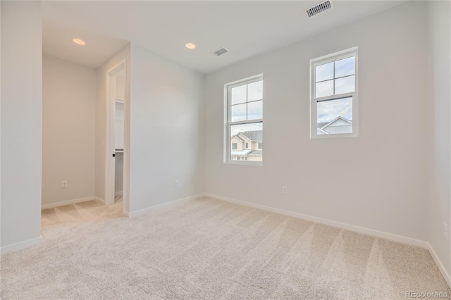 empty room featuring light carpet and a healthy amount of sunlight