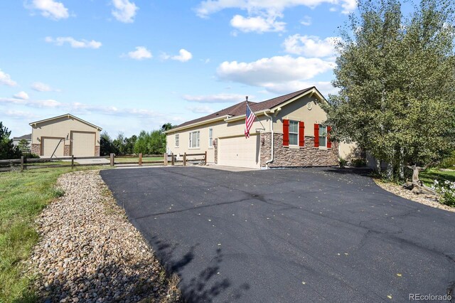 view of front of property with fence, stucco siding, and stone siding