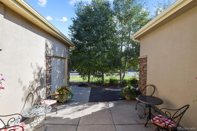 view of patio / terrace with a garage and driveway