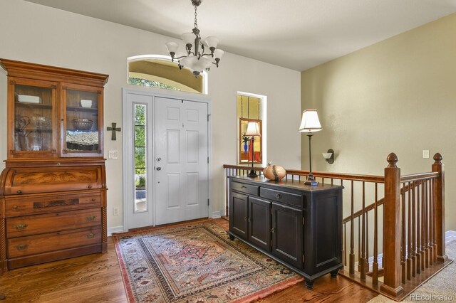 foyer featuring a chandelier and wood finished floors