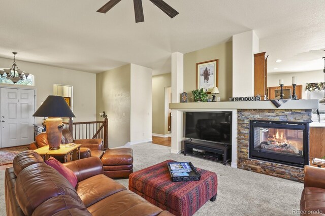 living area with baseboards, carpet, and ceiling fan with notable chandelier