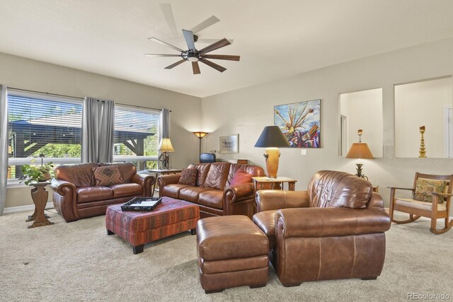 living area with carpet flooring and ceiling fan