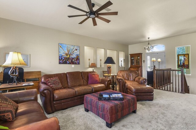 living room with carpet floors and ceiling fan with notable chandelier