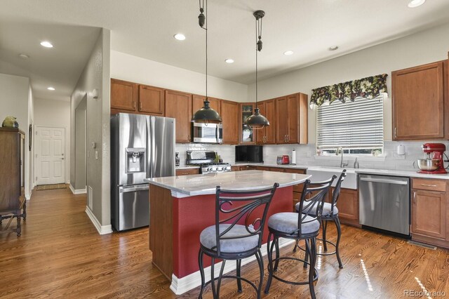 kitchen featuring a sink, decorative backsplash, stainless steel appliances, and recessed lighting
