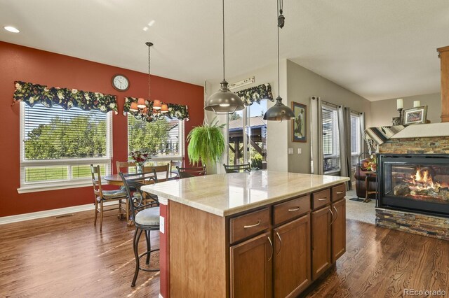 kitchen with a healthy amount of sunlight, dark wood finished floors, and a chandelier