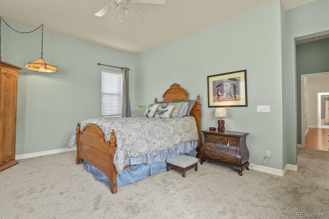 carpeted bedroom with baseboards and a ceiling fan