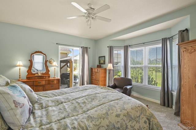 bedroom with carpet floors, multiple windows, baseboards, and ceiling fan