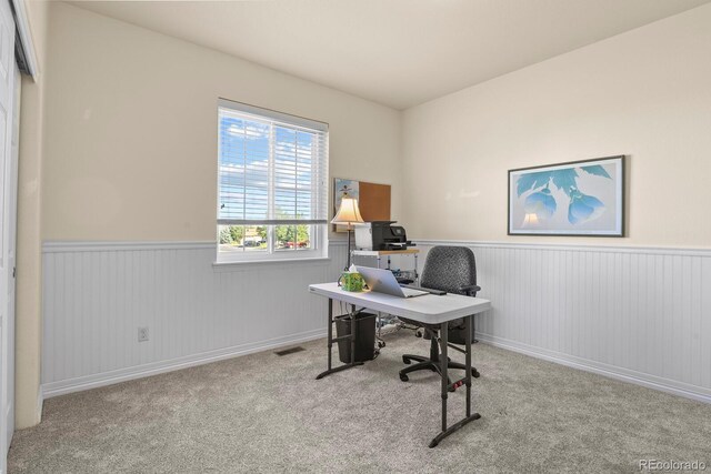 office featuring carpet flooring and a wainscoted wall