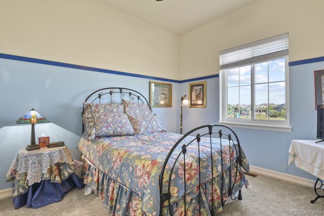 bedroom with carpet floors and baseboards