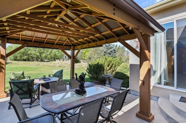 view of patio with a gazebo and outdoor dining space
