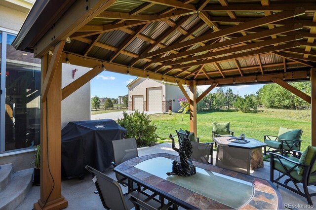 view of patio with area for grilling, a gazebo, a fire pit, and outdoor dining area