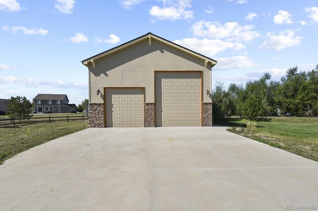 detached garage featuring fence
