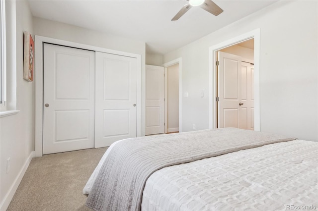 carpeted bedroom with ceiling fan and a closet