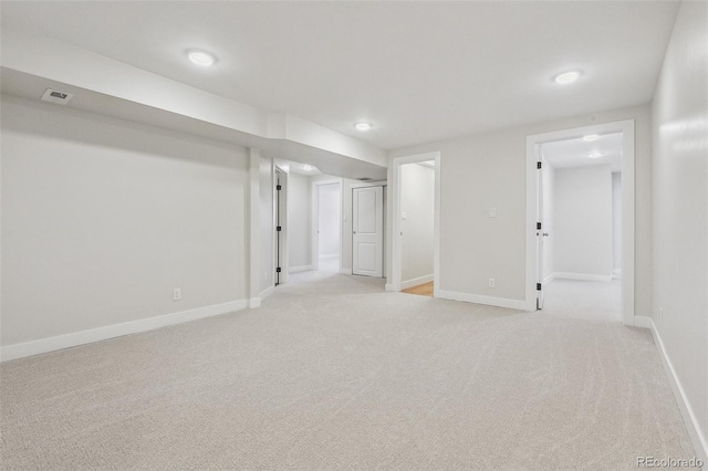 basement featuring light colored carpet