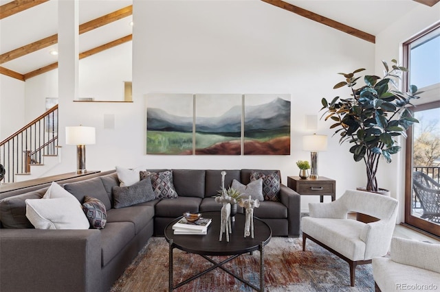 living room with beamed ceiling and high vaulted ceiling