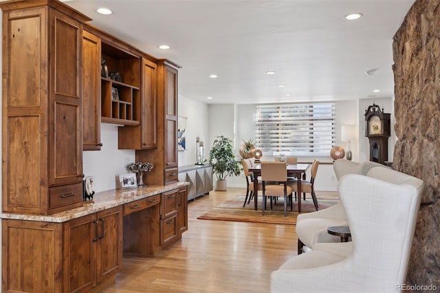 kitchen featuring light stone countertops and light hardwood / wood-style floors