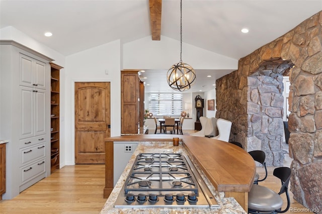 dining room with vaulted ceiling with beams, a notable chandelier, and light hardwood / wood-style flooring